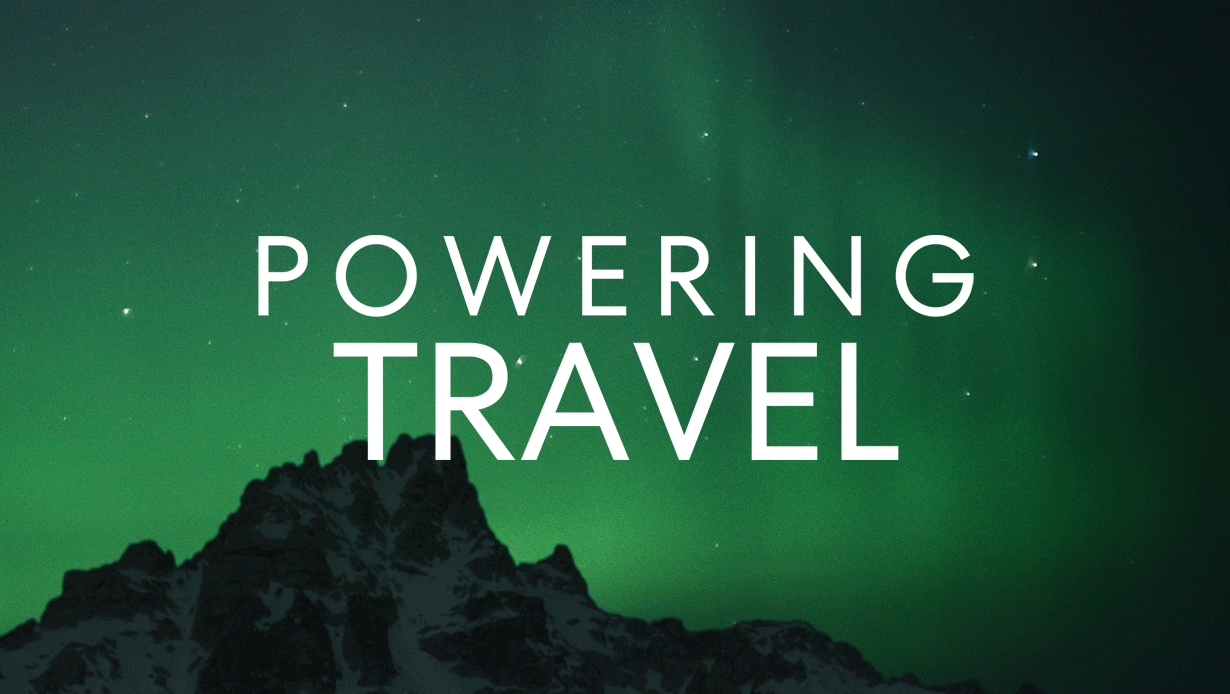 Animated text reading “Powering Travel” over a background of green northern lights above a dark mountain silhouette