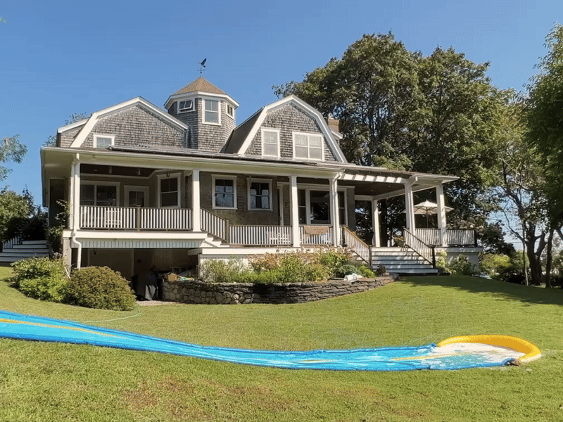 Girl sliding on a slip and slide with a house behind her, followed by an animated Vrbo logo outro