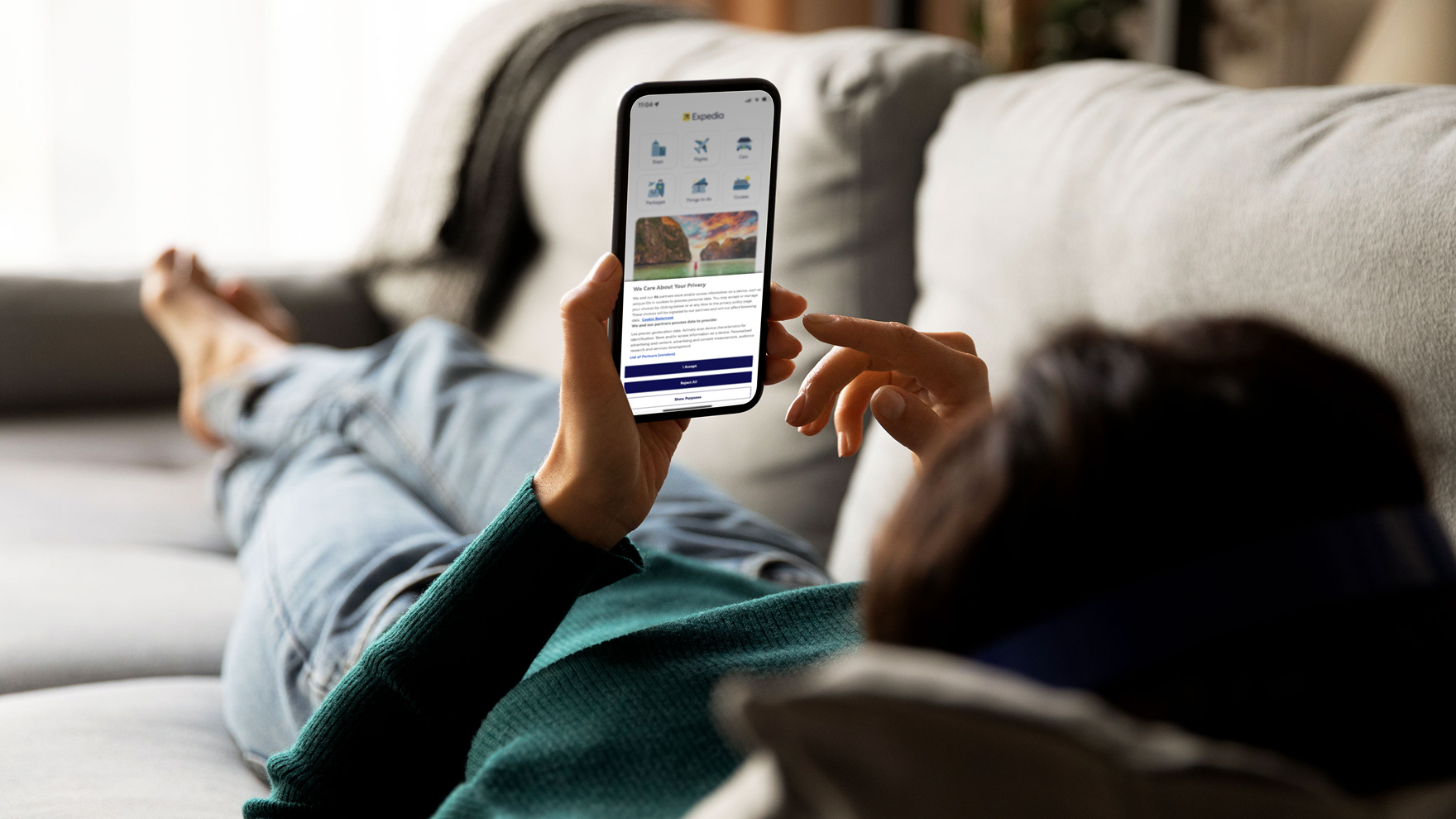 Woman on couch using her cellphone.