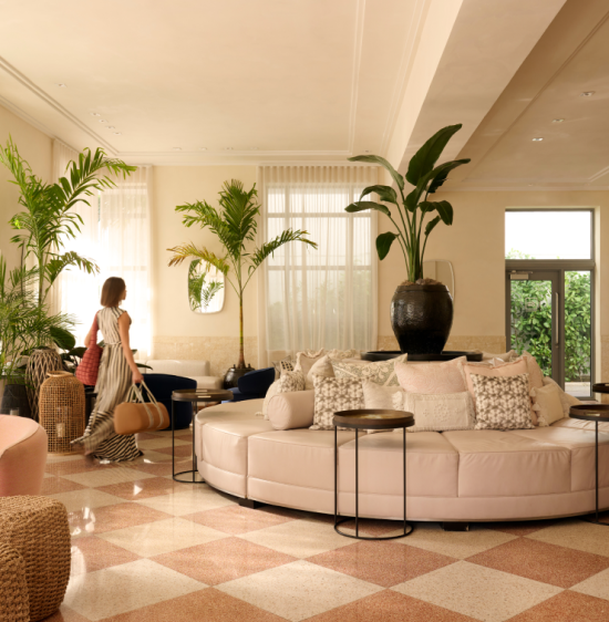 A woman walking accross a luxury hotel lobby