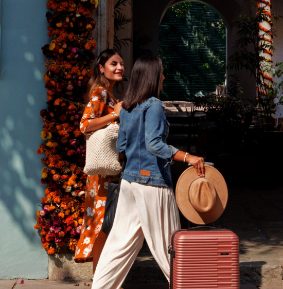 Two women walk into the foyer of a hotel