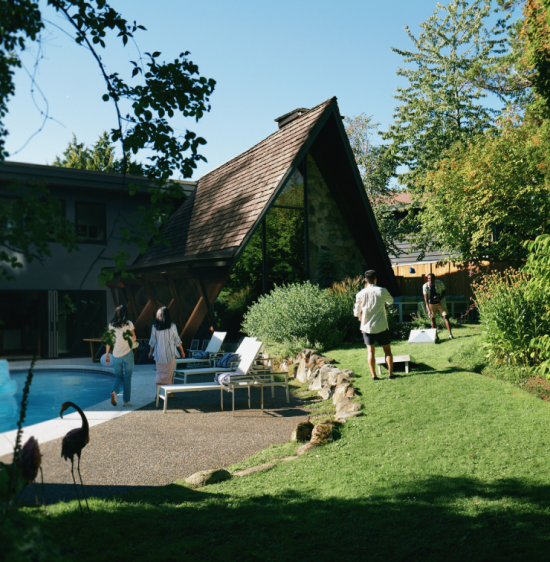 A family walking near the outdoor pool of their vacation rental