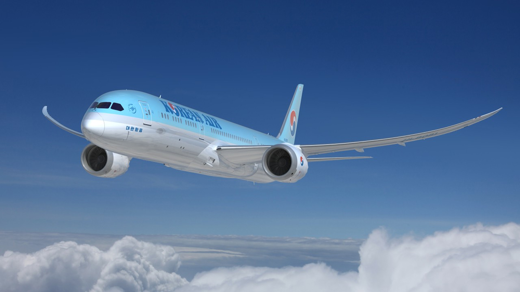  Blue Korean Airlines aeroplane flying above white clouds with blue sky in the background