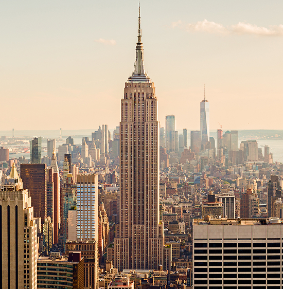 Cityscape view of New York featuring the Empire State Building and surrounding skyscrapers